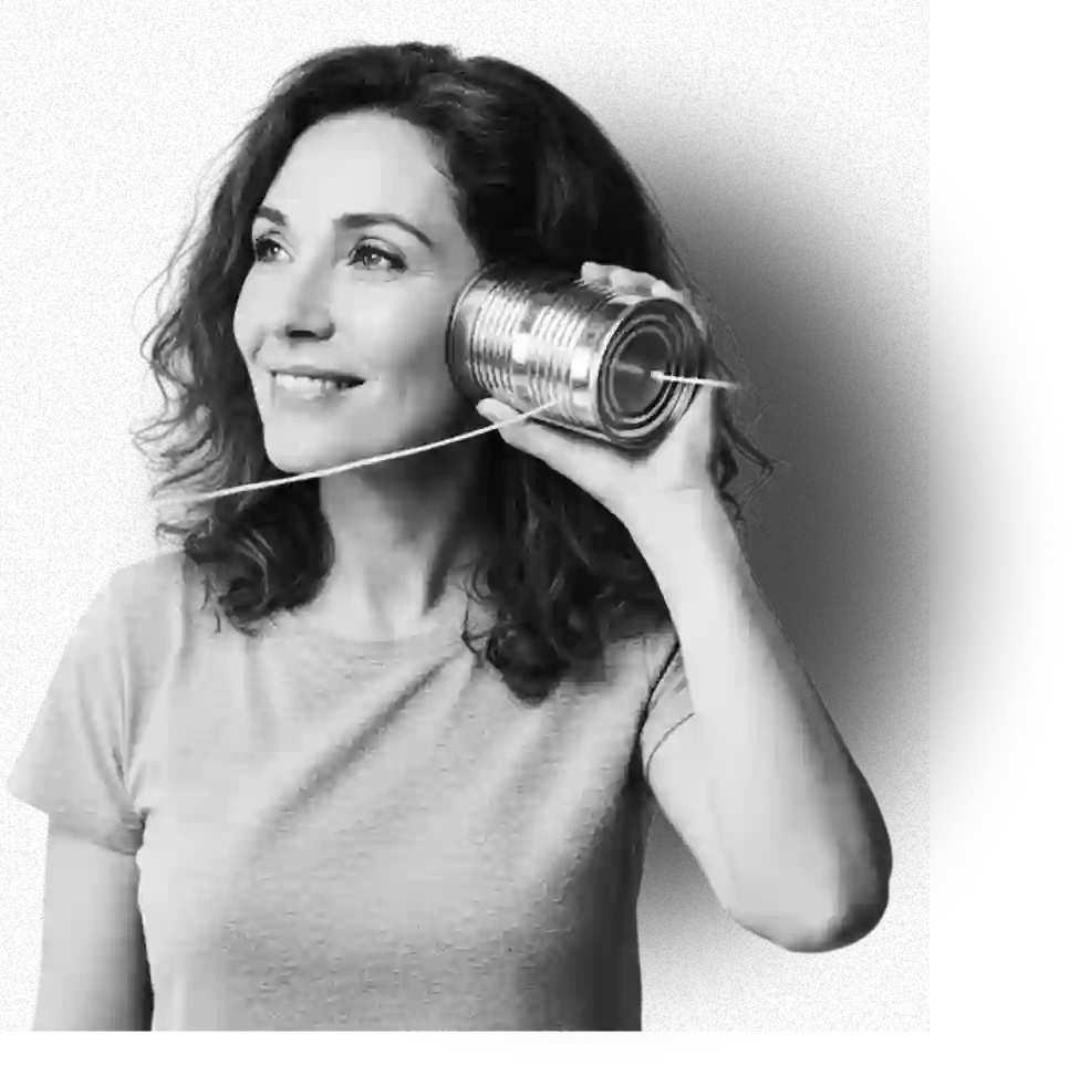 Woman smiling while listening through a tin-can telephone, representing connection with gifting experts  